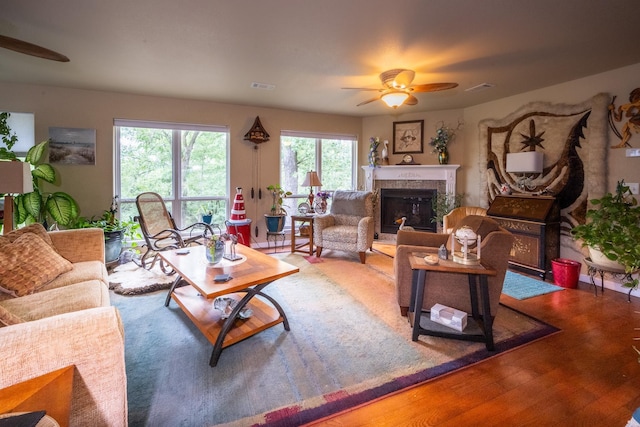 living room with wood-type flooring and ceiling fan