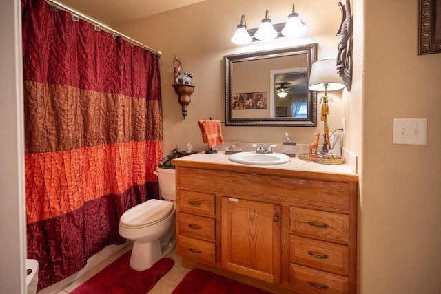 bathroom featuring curtained shower, toilet, vanity, and tile patterned flooring