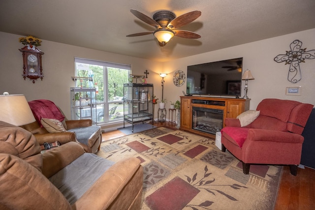 living room with ceiling fan and hardwood / wood-style floors