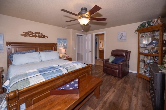 bedroom featuring ceiling fan, dark hardwood / wood-style floors, and a textured ceiling