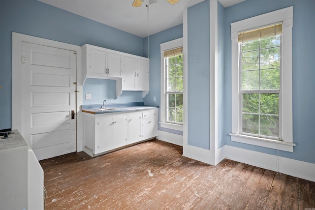 kitchen featuring white cabinetry, hardwood / wood-style floors, and ceiling fan