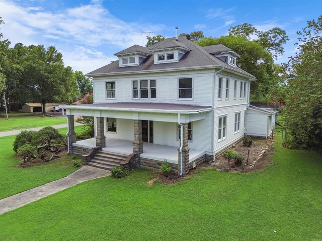 traditional style home with a porch and a front yard