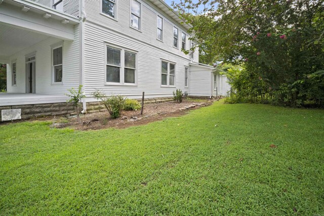 view of property exterior with a lawn