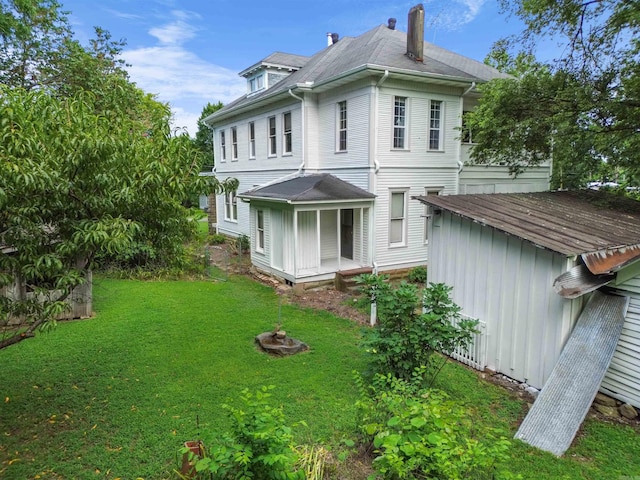 back of property featuring a lawn