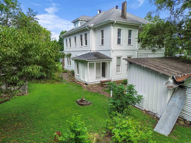 view of side of home with a yard