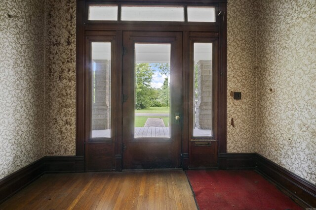 entryway with wallpapered walls and hardwood / wood-style flooring