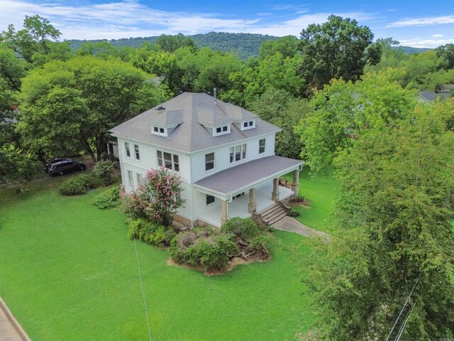 drone / aerial view with a wooded view