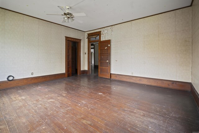 spare room featuring baseboards, a ceiling fan, hardwood / wood-style floors, and crown molding