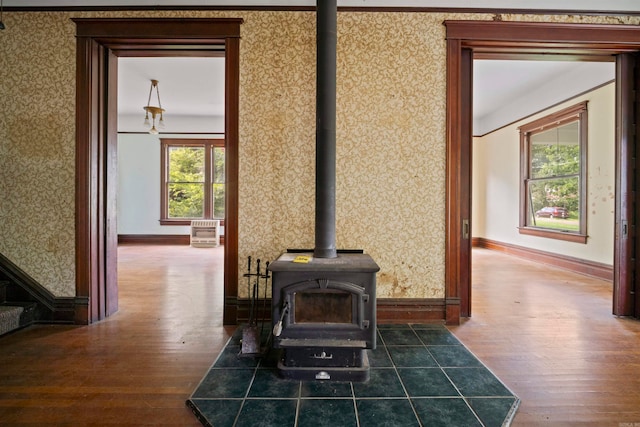 interior details with a wood stove and hardwood / wood-style floors