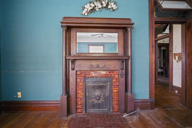 interior details featuring a brick fireplace and ceiling fan