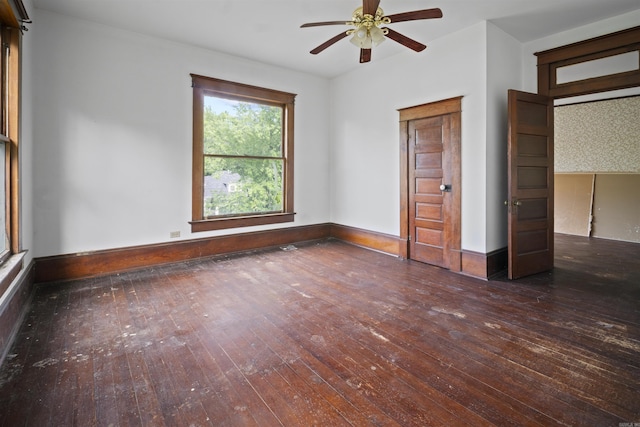 unfurnished bedroom with baseboards, hardwood / wood-style floors, and a ceiling fan