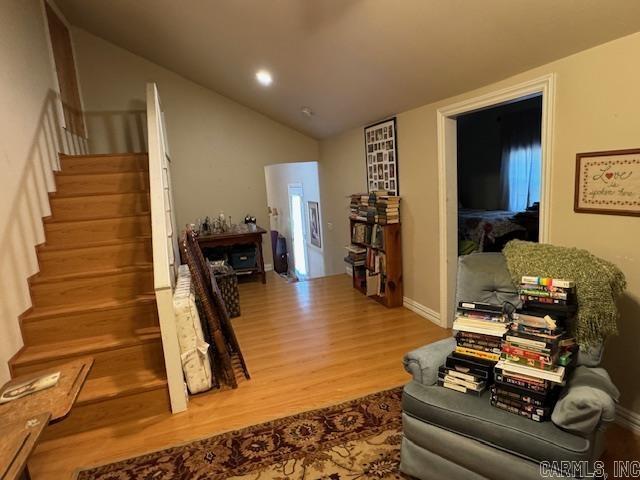 interior space featuring vaulted ceiling and hardwood / wood-style flooring