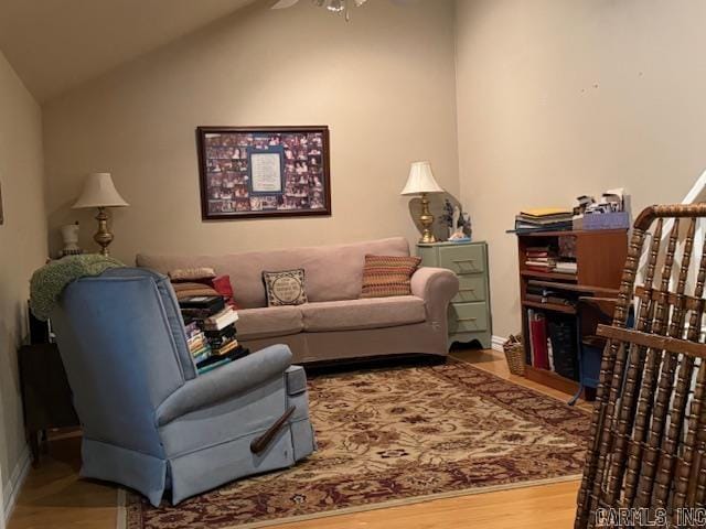 living room with ceiling fan, hardwood / wood-style floors, and lofted ceiling