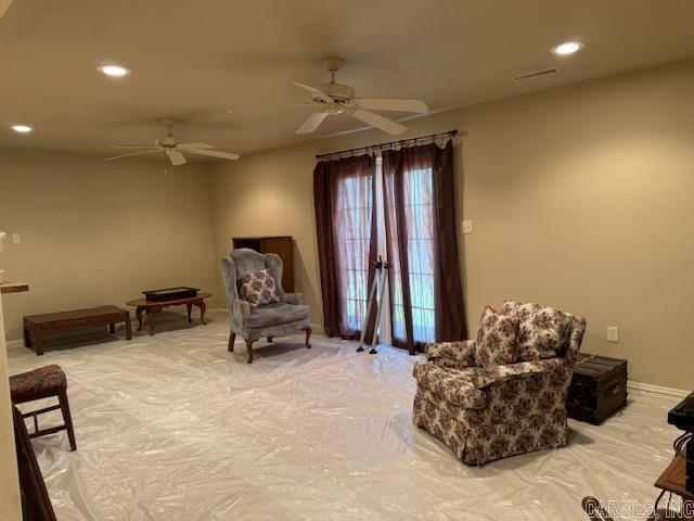 living area featuring ceiling fan and french doors