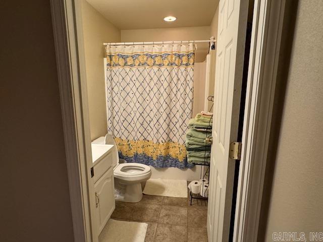 bathroom with toilet, vanity, and walk in shower