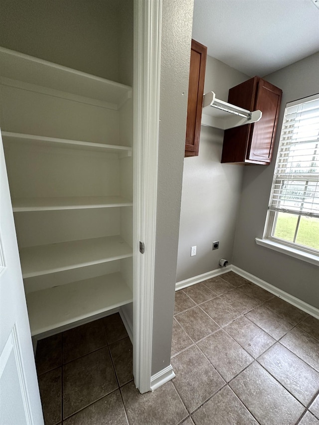 washroom featuring light tile patterned flooring and electric dryer hookup