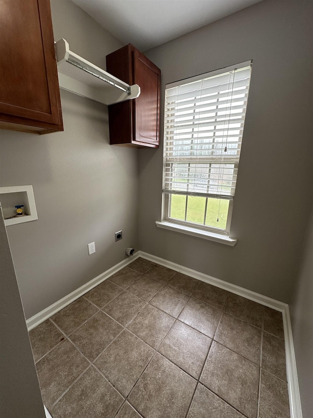 laundry room featuring cabinets, tile patterned flooring, hookup for a washing machine, and electric dryer hookup