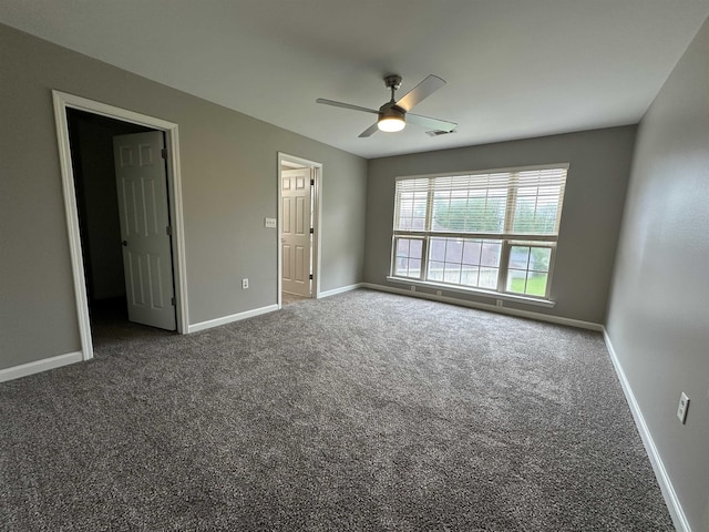 carpeted empty room featuring ceiling fan