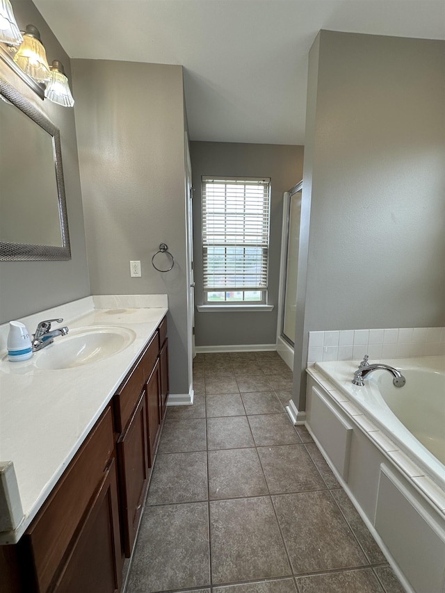 bathroom with vanity, tile patterned flooring, and plus walk in shower