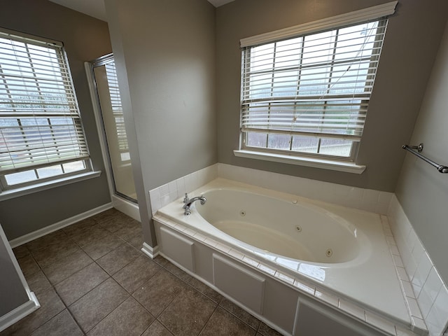 bathroom featuring independent shower and bath, tile patterned floors, and plenty of natural light