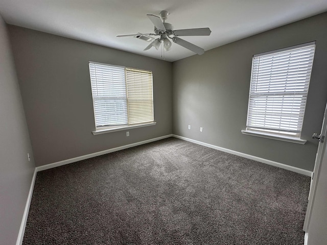 spare room featuring ceiling fan and carpet floors