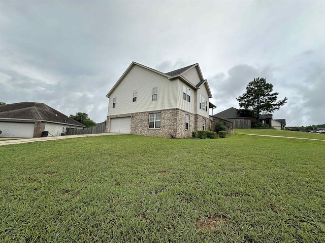 view of side of home with a garage and a yard