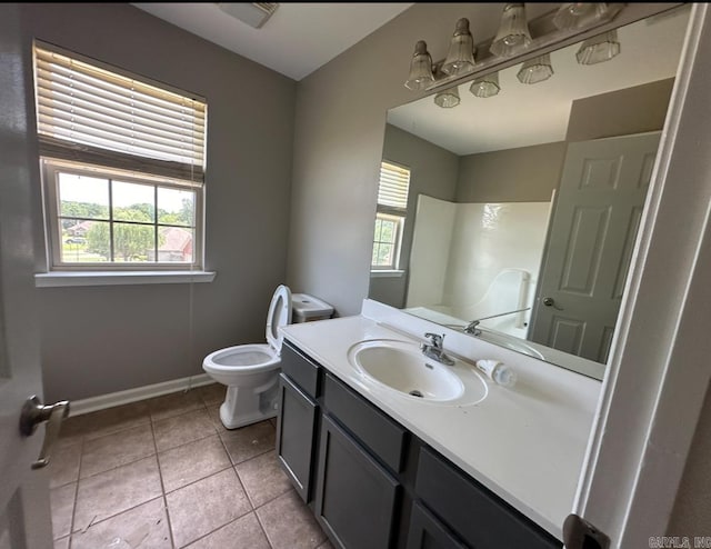 bathroom with a shower, tile patterned floors, plenty of natural light, and vanity