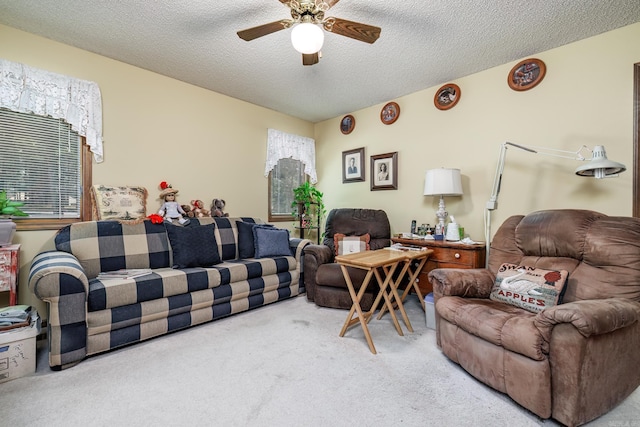 carpeted living room featuring ceiling fan, a healthy amount of sunlight, and a textured ceiling