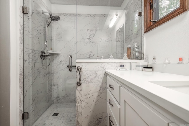 bathroom featuring vanity, a textured ceiling, and walk in shower