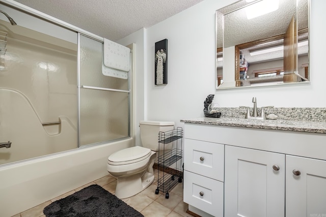 full bathroom with combined bath / shower with glass door, a textured ceiling, toilet, tile patterned floors, and vanity