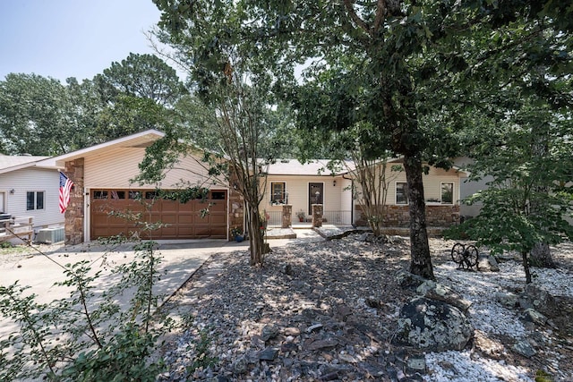 ranch-style house with a garage and cooling unit