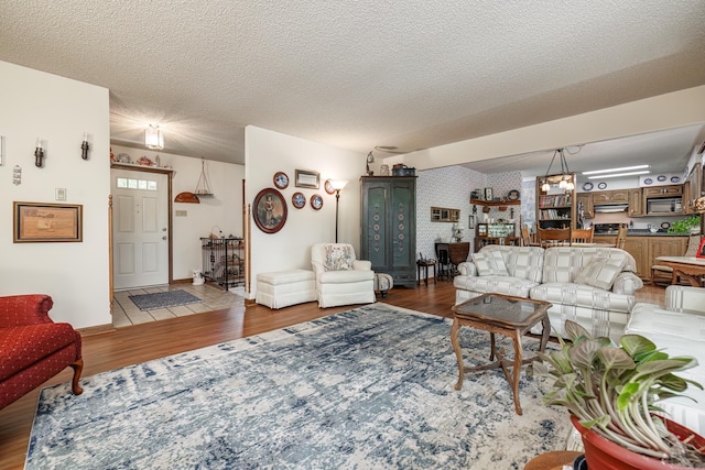 living room featuring light hardwood / wood-style floors and a textured ceiling