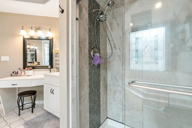 bathroom with vanity, a shower with door, and tile patterned floors