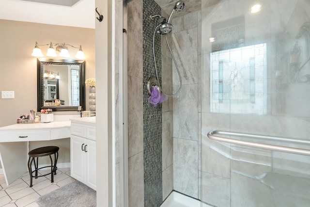 bathroom featuring tile patterned flooring, a shower with shower door, and vanity