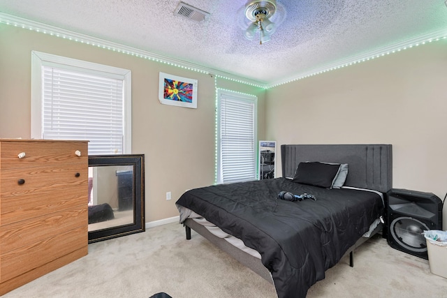 carpeted bedroom with a textured ceiling and ornamental molding