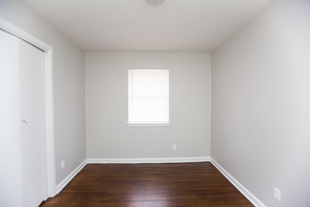 empty room with dark hardwood / wood-style floors