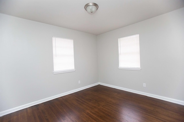 unfurnished room with dark hardwood / wood-style floors