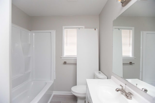 full bathroom featuring plenty of natural light, bathtub / shower combination, toilet, and vanity