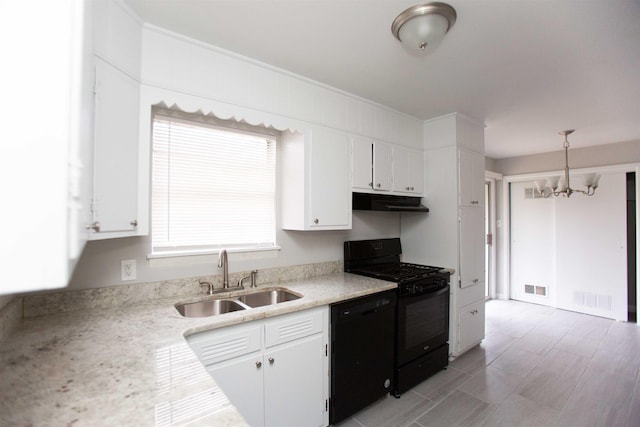 kitchen with white cabinetry, hanging light fixtures, and black appliances