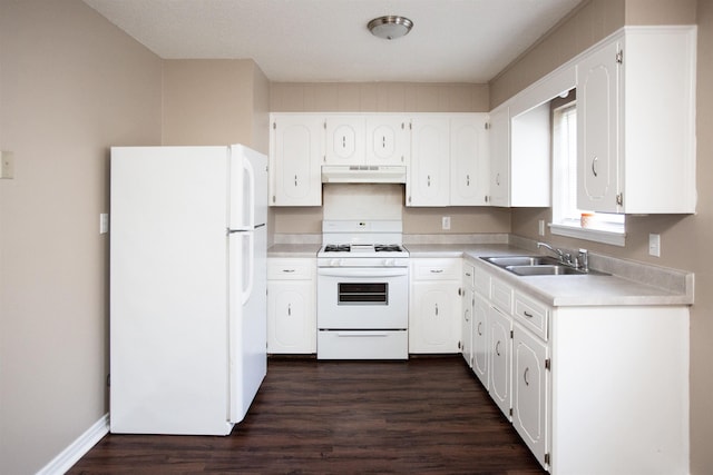 kitchen with dark wood-type flooring, sink, white appliances, and white cabinetry