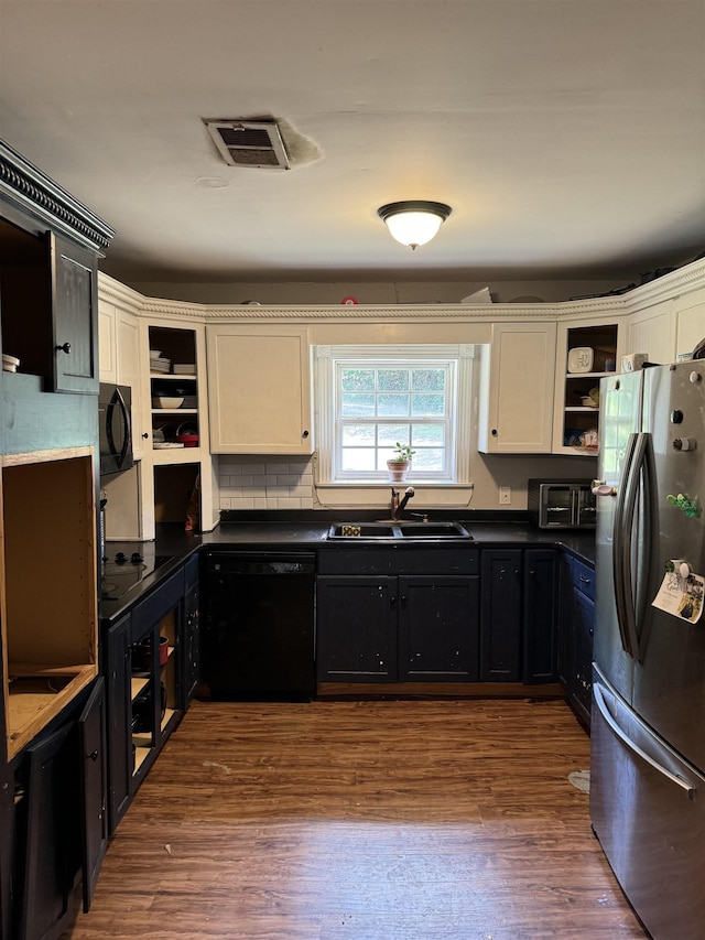 kitchen with black appliances, white cabinets, sink, dark hardwood / wood-style flooring, and backsplash