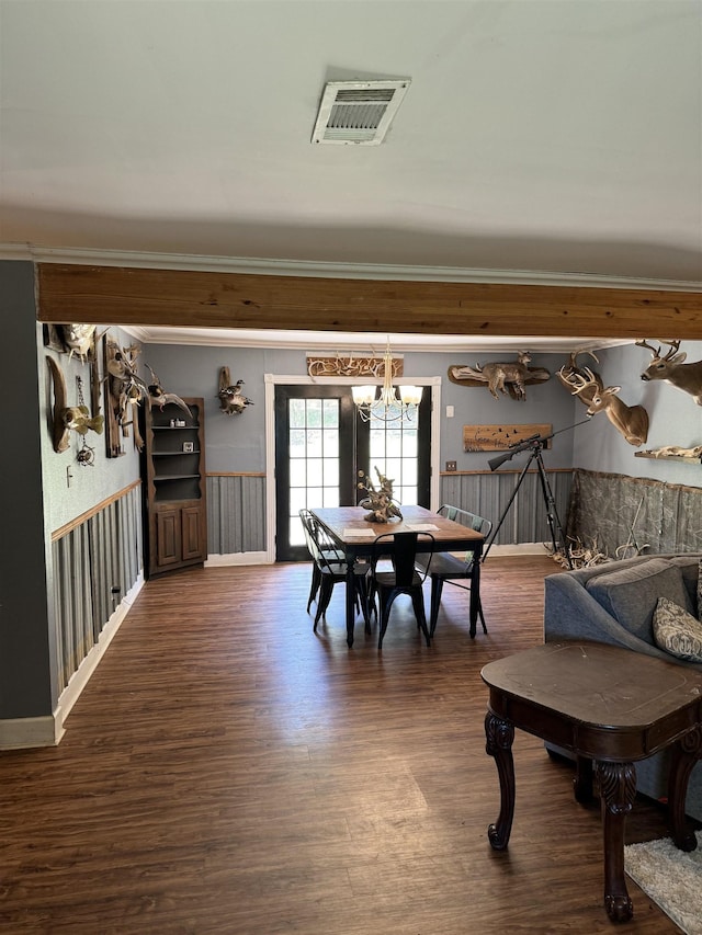 dining space featuring dark hardwood / wood-style floors and a chandelier