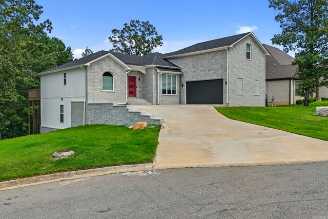 view of front facade with a garage and a front lawn