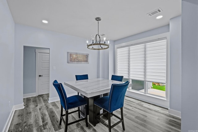 dining room with a chandelier and hardwood / wood-style flooring