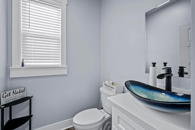 bathroom featuring toilet and vanity