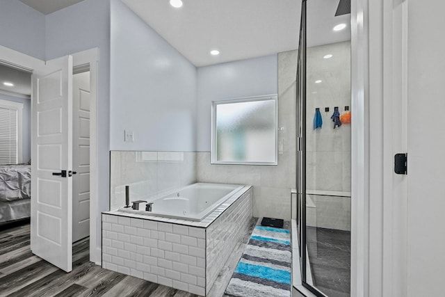 bathroom with plus walk in shower and hardwood / wood-style flooring