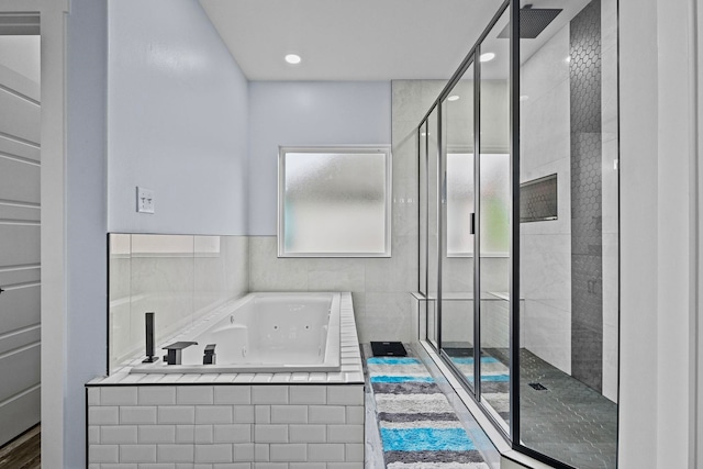 bathroom featuring separate shower and tub