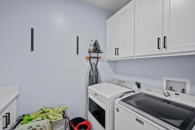 laundry area featuring cabinets and washing machine and dryer