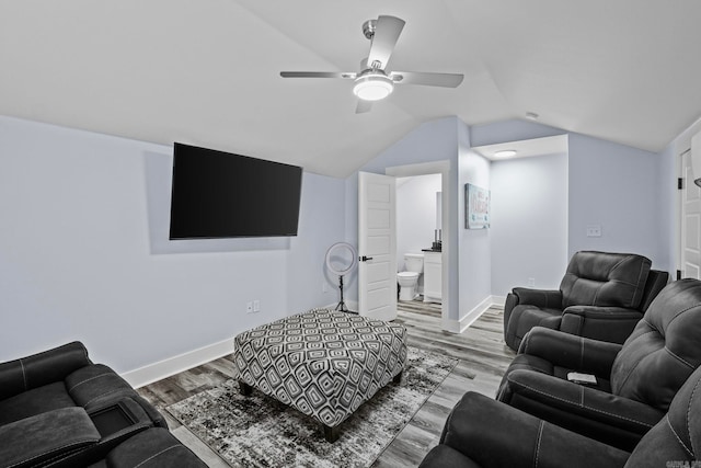 living room featuring ceiling fan, vaulted ceiling, and light hardwood / wood-style floors