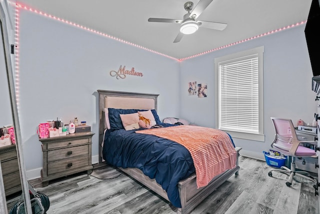 bedroom with ceiling fan and wood-type flooring